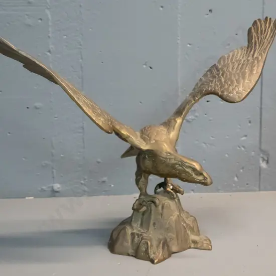 cast brass figure of an eagle with wings spread, standing on rocks - crack to one wing H-285 W-390