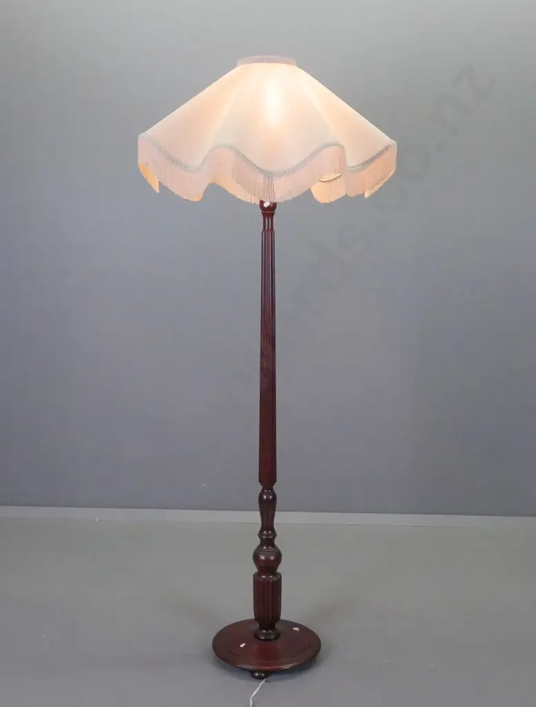 mahogany standard lamp with fluted column and turned base on 3 bun feet & scalloped edge ivory colour shade. Some stains Image 1++