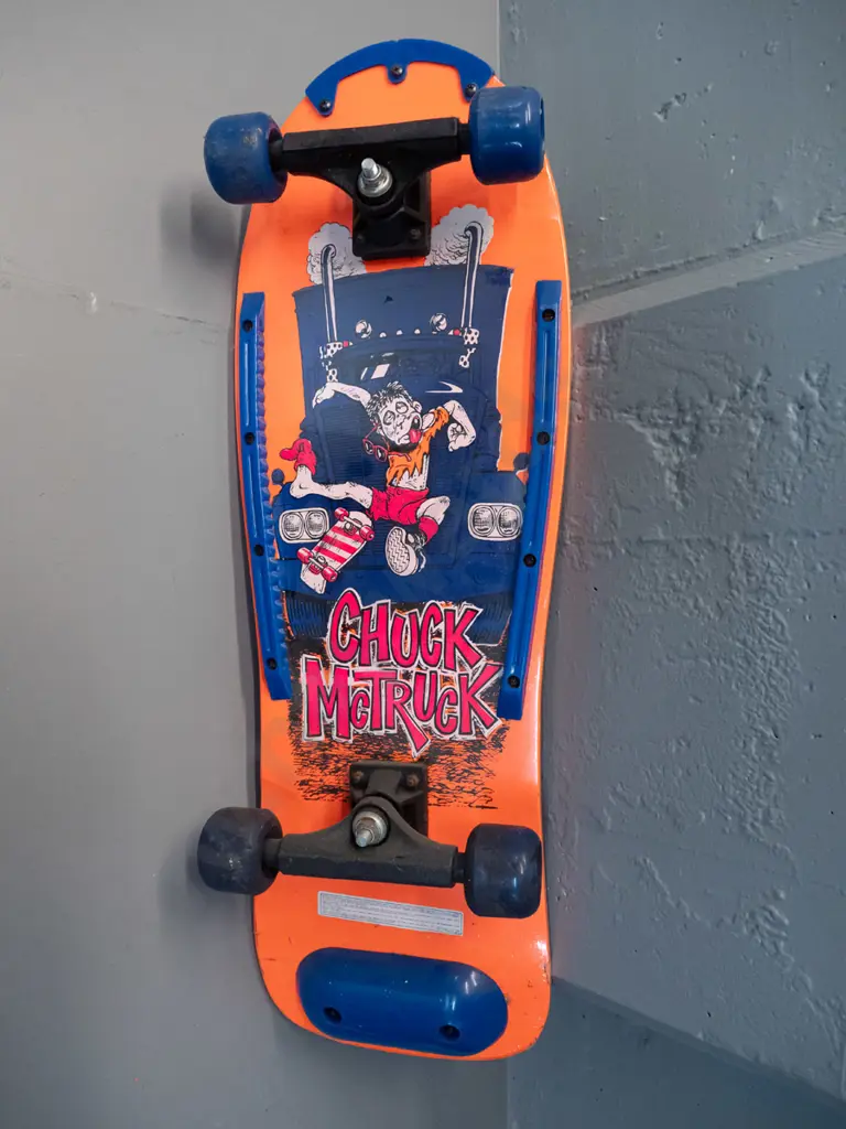 circa 1990s skateboard - Chuck McTruck and "Skika" graphics, still has plastic wrap, wheels stiff L-765 W-260 Image 1++