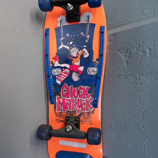 circa 1990s skateboard - Chuck McTruck and "Skika" graphics, still has plastic wrap, wheels stiff L-765 W-260