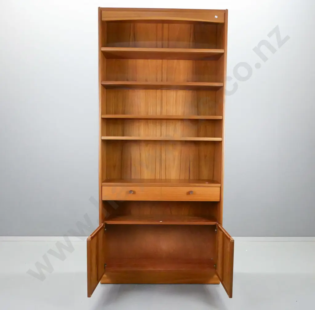 mid-century Parker Knoll teak bookcase with 1 fixed and 3 adjustable shelves, 1 drawer, 2 panelled cupboard doors, Image 1++