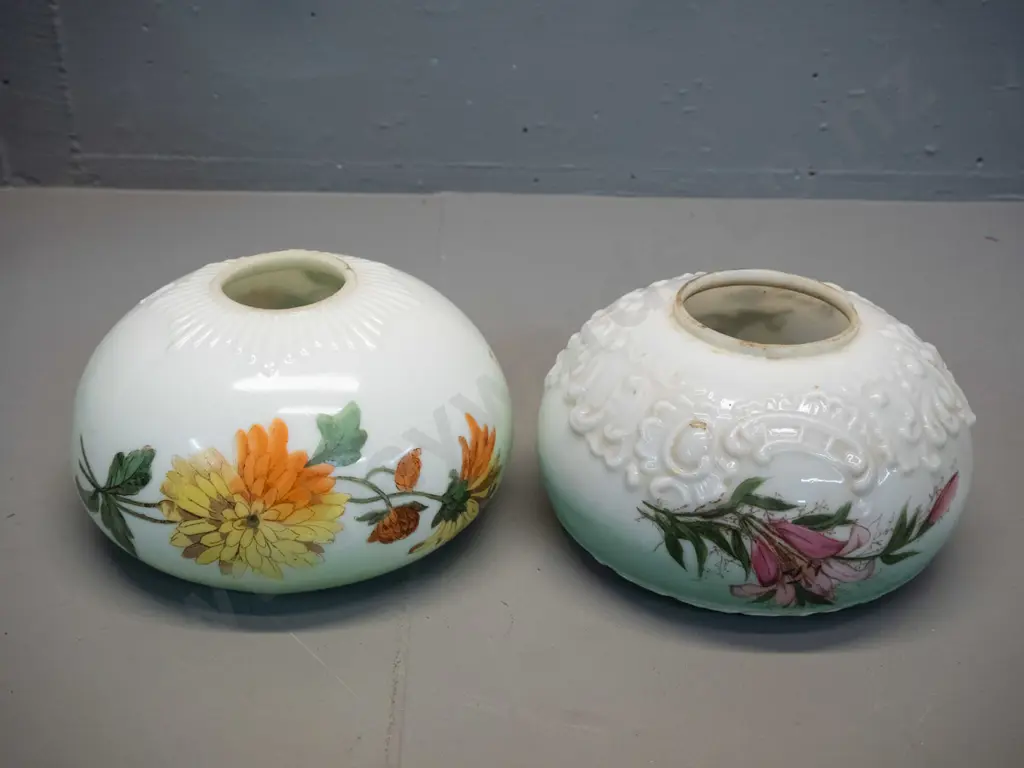 two deco hand-painted-over-transfer milk glass light shades - floral motifs on green, one with chips inside bottom rim. Image 1++
