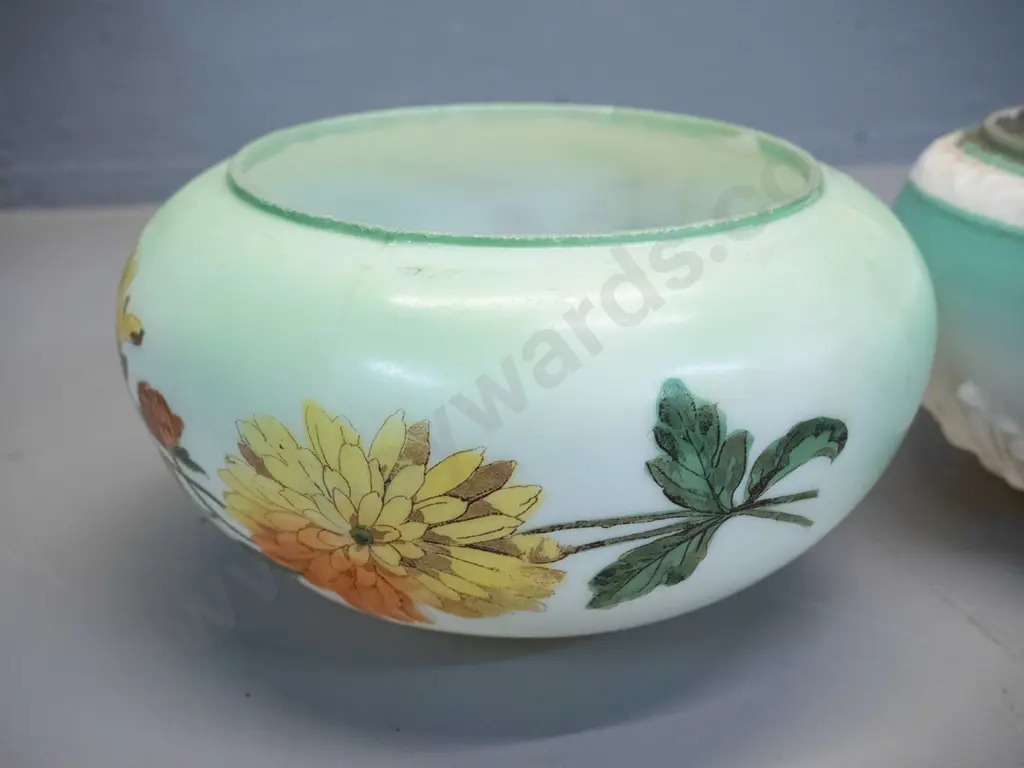 two deco hand-painted-over-transfer milk glass light shades - floral motifs on green, one with chips inside bottom rim. Image 1++