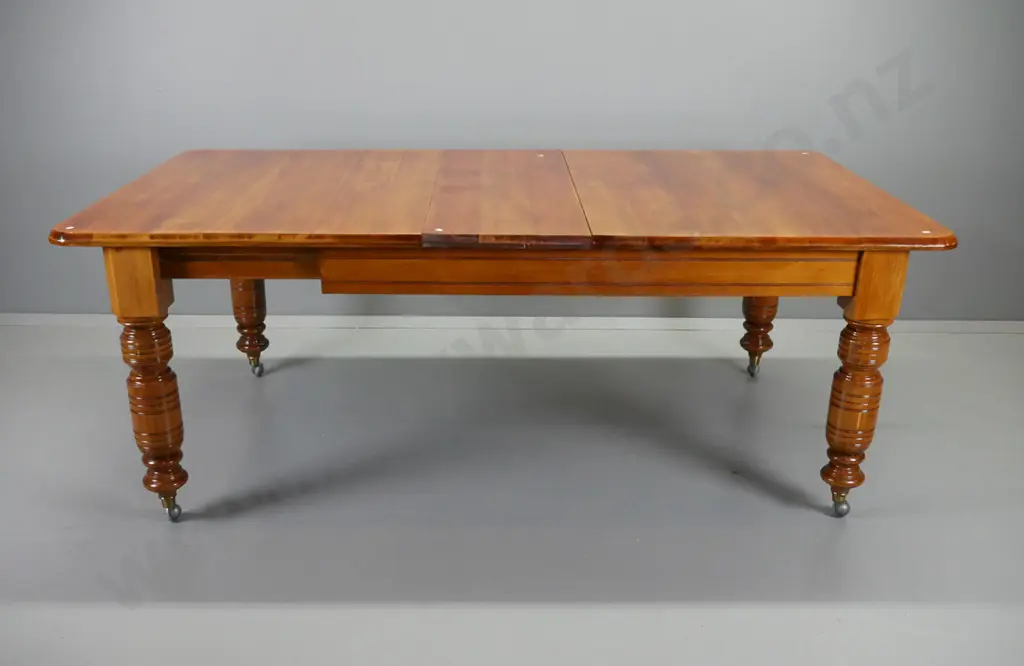 Victorian rimu wind-out extending dining table on heavy turned legs with brass caps and replacement Shepherd's casters - Image 1++