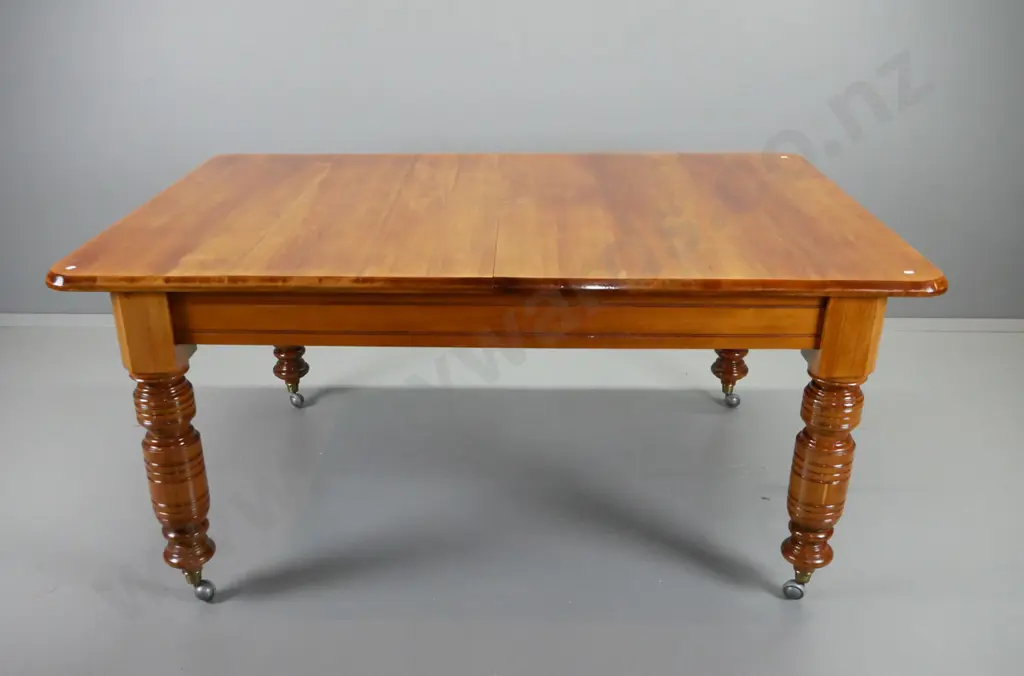 Victorian rimu wind-out extending dining table on heavy turned legs with brass caps and replacement Shepherd's casters - Image 1++