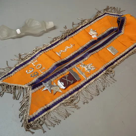 lodge sash with assorted plated metal decorations and a deco style figural frosted glass stopper, chips to stopper end.