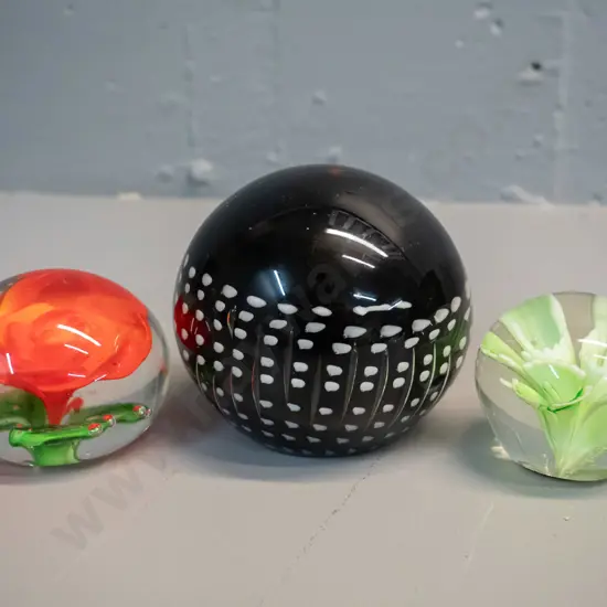 3 glass paperweights - large black with white speckled pattern D-90 has "Smashing Art Glass" sticker