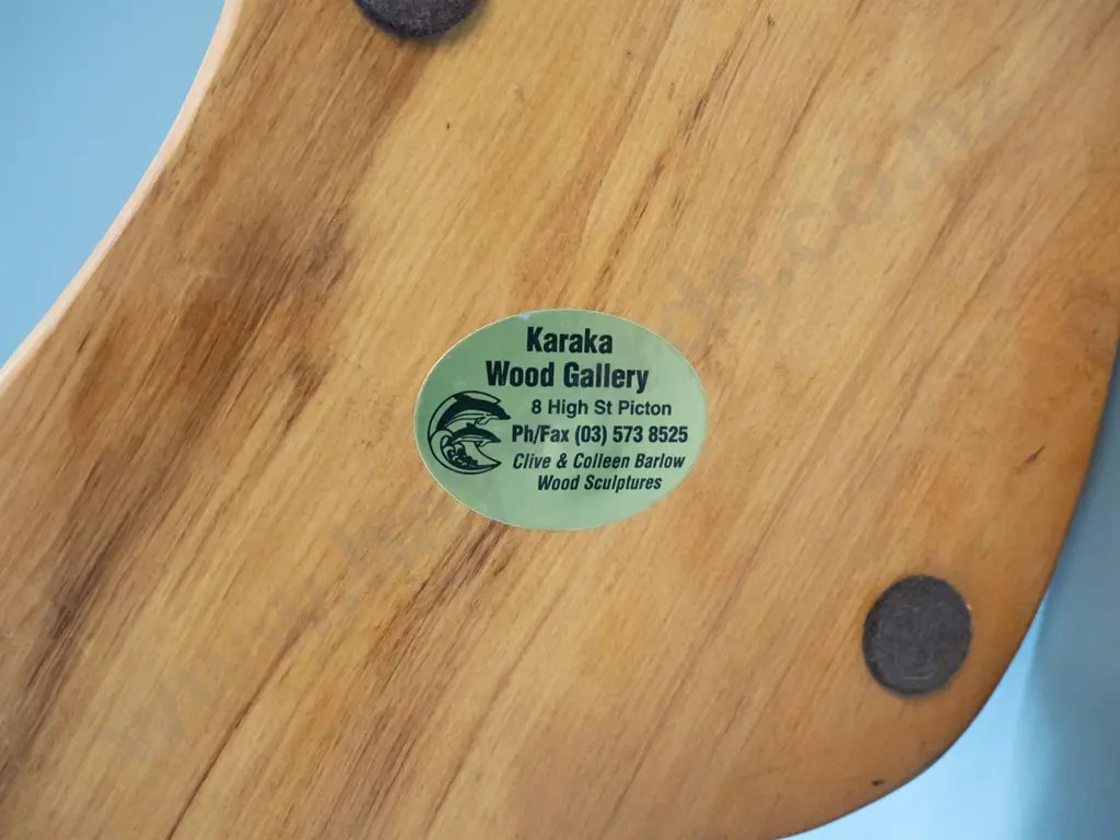 carved rimu figure of two leaping dolphins on piece of driftwood, label on base for Karaka Wood Gallery, Picton H-370 Image 1++