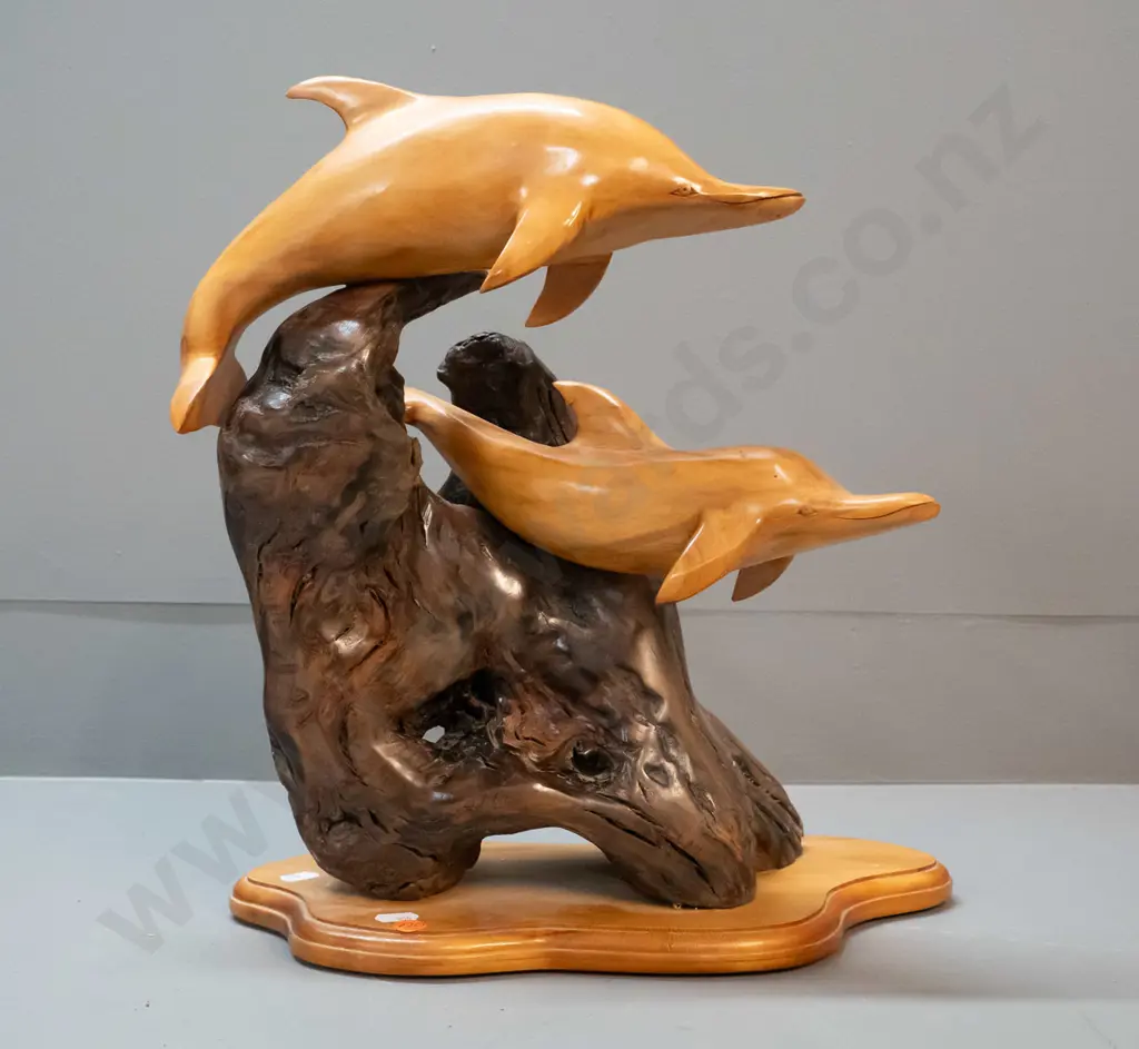 carved rimu figure of two leaping dolphins on piece of driftwood, label on base for Karaka Wood Gallery, Picton H-370 Image 1++