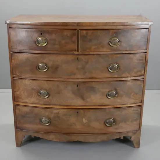 regency mahogany 5-drawer bow-front chest, w/shaped base on bracket feet, oval brass drawer plates, some fading to