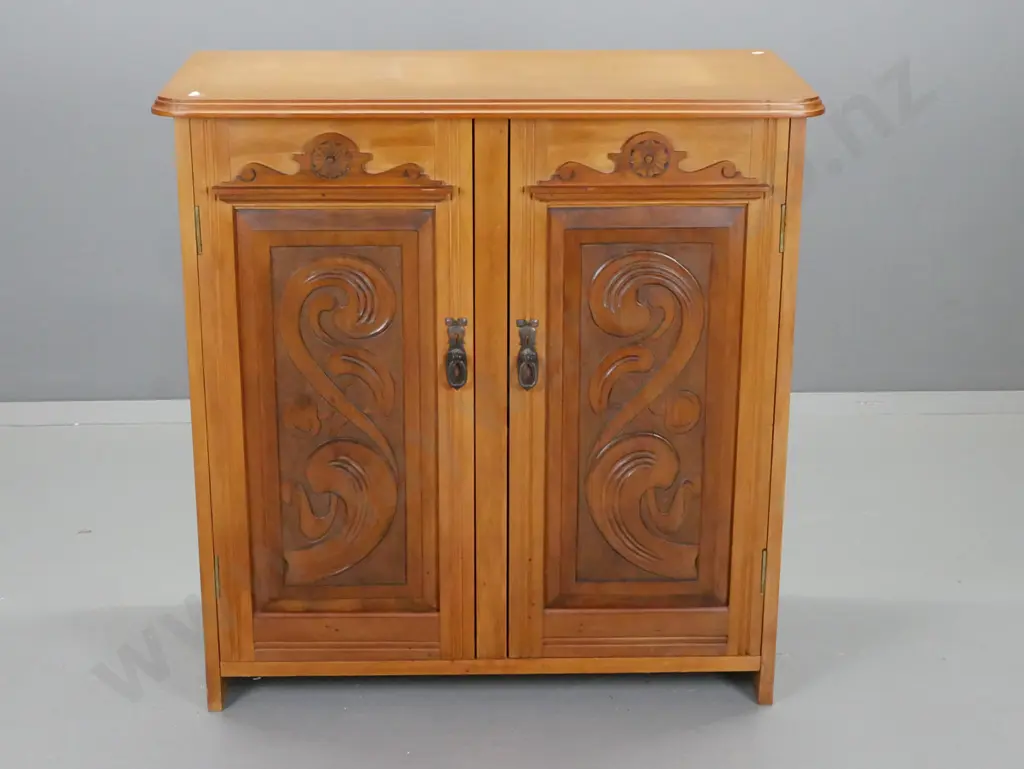 kauri and rimu 2-door cupboard with carved panelled doors and crests, drop handles, 2 interior shelves, assembled from Image 1++
