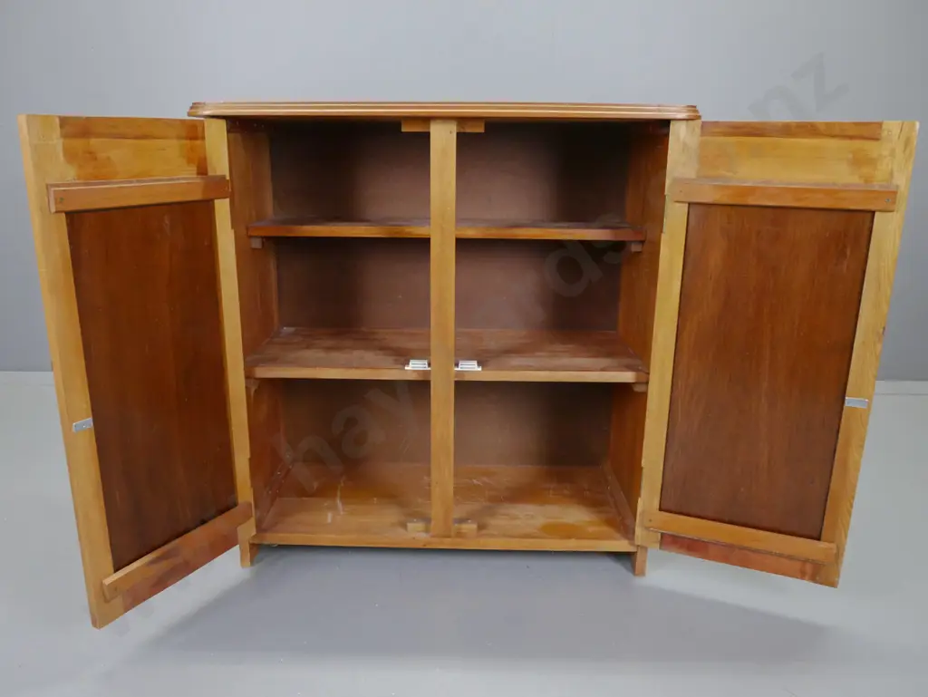 kauri and rimu 2-door cupboard with carved panelled doors and crests, drop handles, 2 interior shelves, assembled from Image 1++
