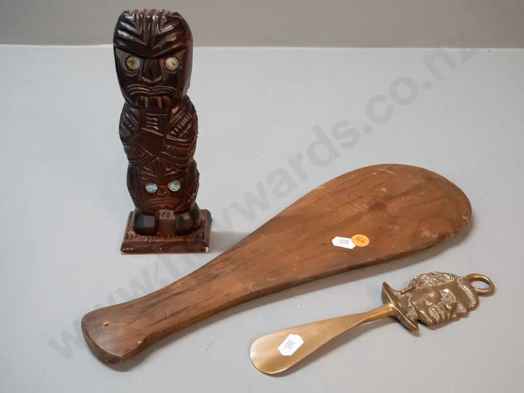 3 small souvenir items - carved timber tiki figure with paua insets, a cast brass shoe-horn and a plain timber mere with Image 1++