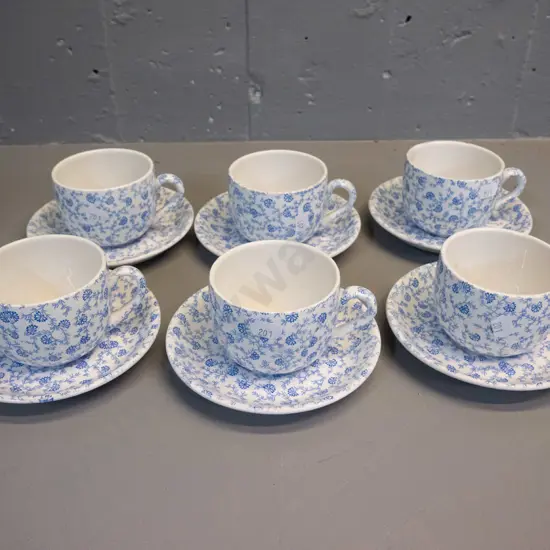 6 blue & white floral cups & saucers, marked Scoullar Dunedin & Dunn Bennett Burslem England - some scratches to