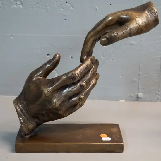 brass or brass finish composite figure of two joined hands on rectangular base H-265 W-280 D-90