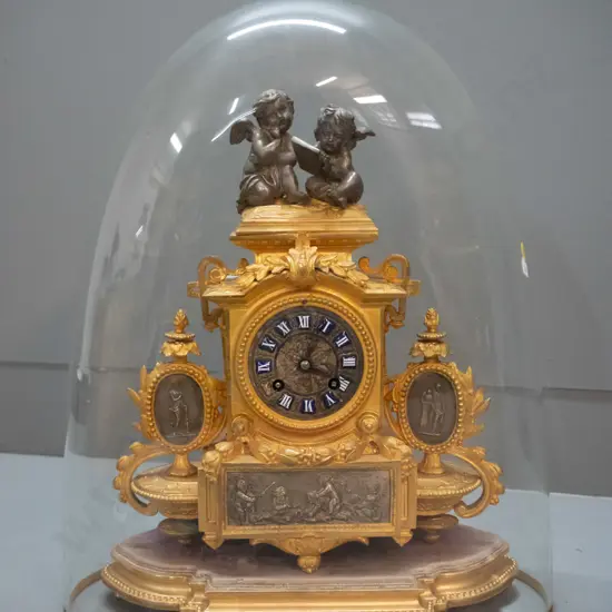 vintage ornate figural cast metal French mantel clock on timber with base glass dome, case stamped "PH Mourey"