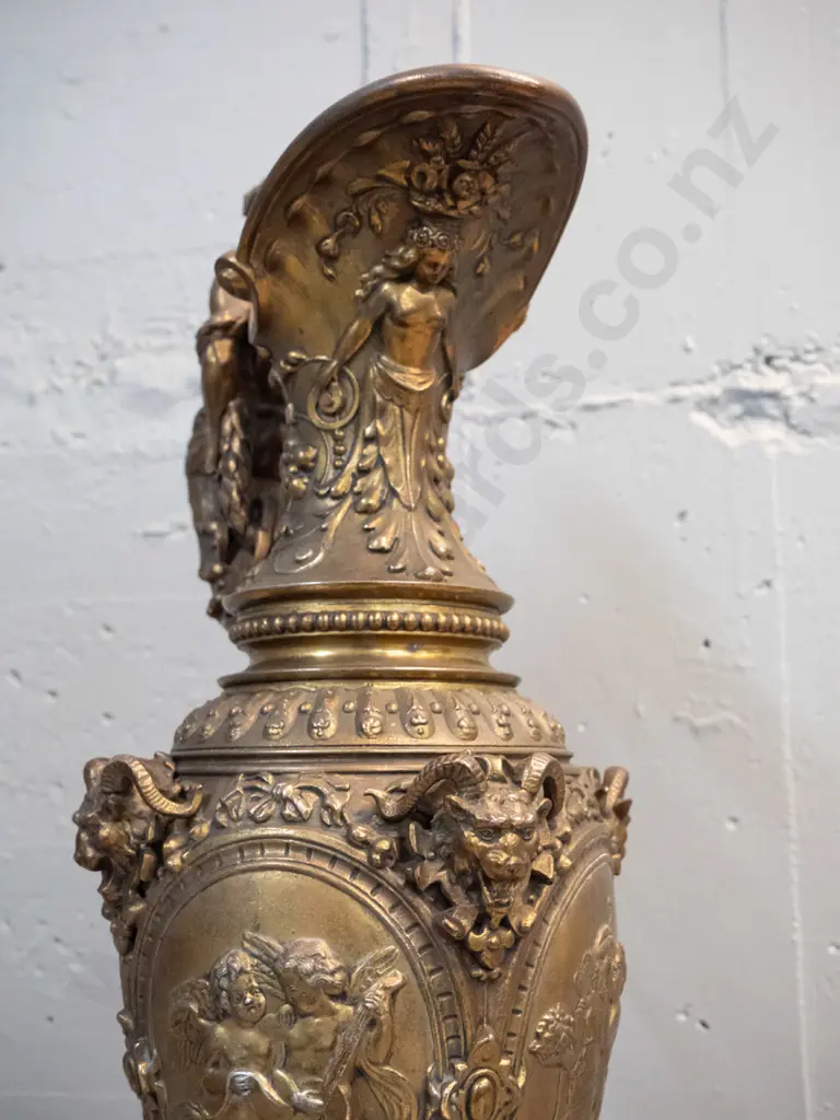 heavy cast metal urn with classical figural motifs, ram's heads, male figural handle, timber base H-610 D-220 at base Image 1++