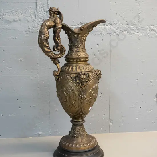 heavy cast metal urn with classical figural motifs, ram's heads, male figural handle, timber base H-610 D-220 at base