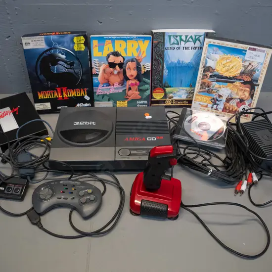 early 90s Commodore Amiga CD32 games console with power supply, 2 controllers, cables, and 5 boxed games - untested