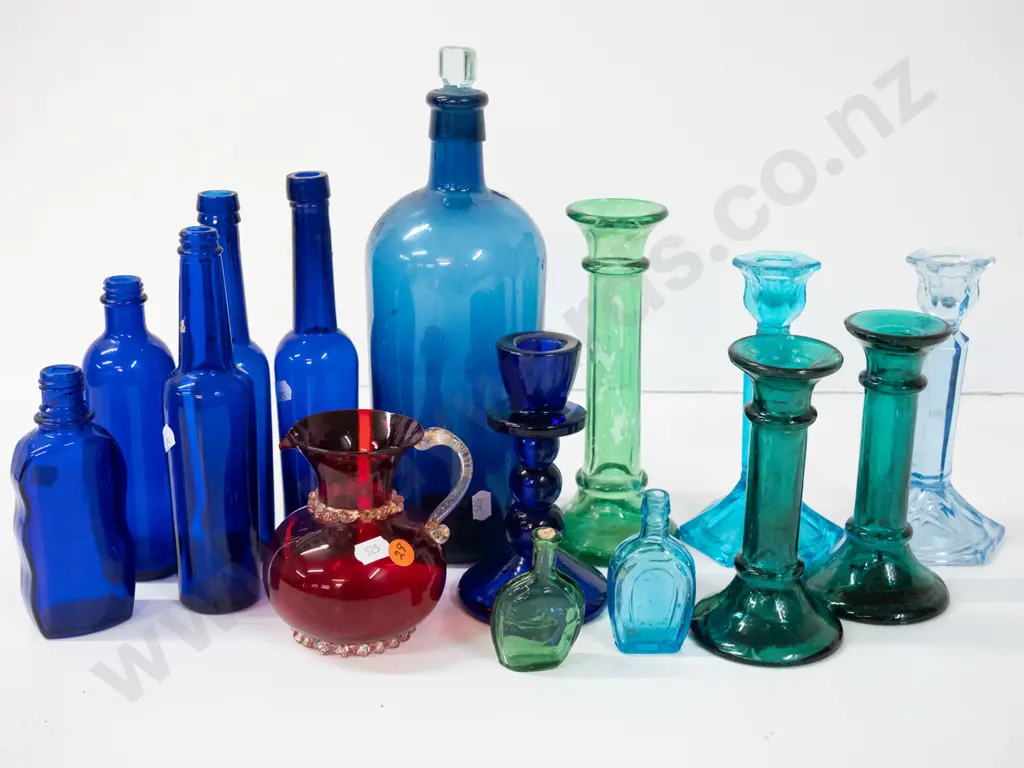 assorted coloured glass items - moulded candlesticks, cobalt blue bottles, ruby jug, etc - one candlestick has been Image 1++