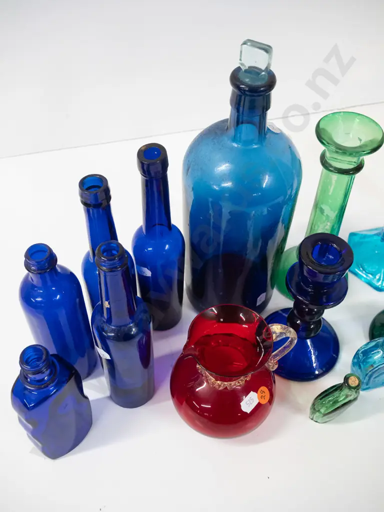 assorted coloured glass items - moulded candlesticks, cobalt blue bottles, ruby jug, etc - one candlestick has been Image 1++