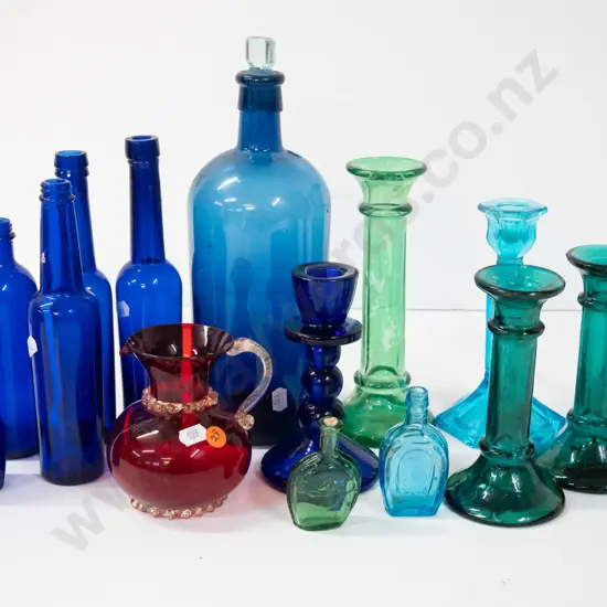 assorted coloured glass items - moulded candlesticks, cobalt blue bottles, ruby jug, etc - one candlestick has been