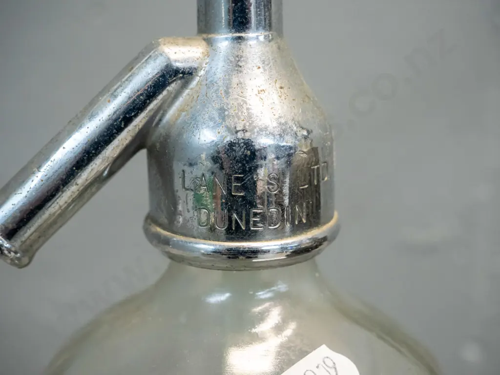 2 vintage soda syphons - one with Lane's Dunedin Oamaru mark to bottle and chrome top, other with wire mesh - some Image 1++