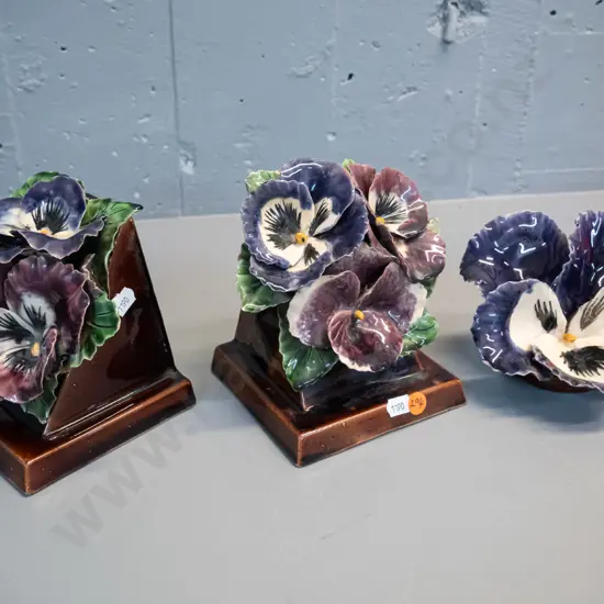 3 hand potted applied pansy motif pottery items - pair of book-ends H-150 W-120 and matching wall hanging. A few chips