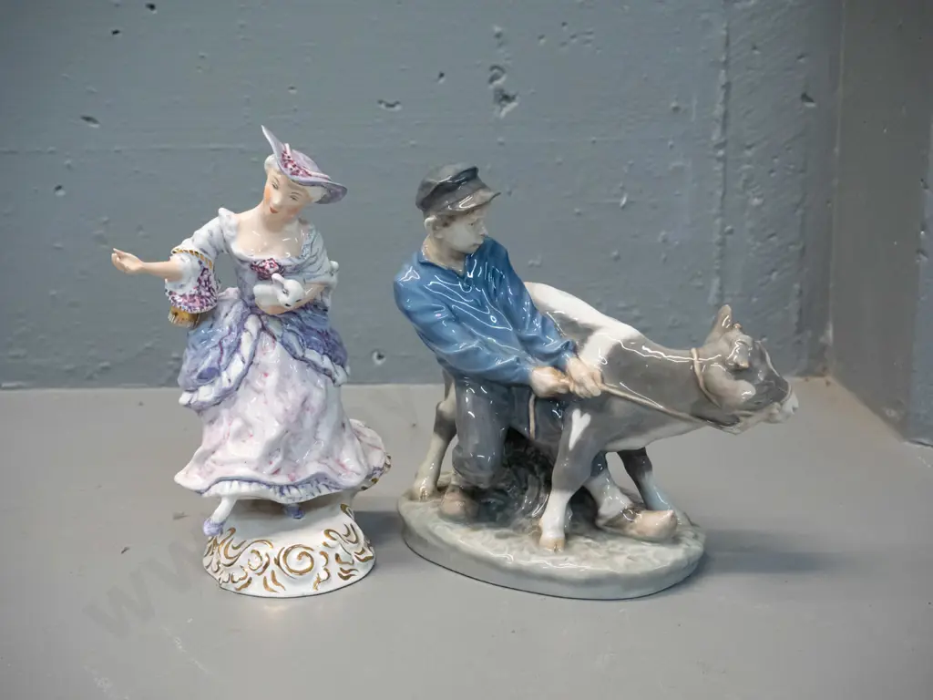 2 figurines - Wedgwood Shepherdess hand painted with a glaze fault to hand H185 and a Royal Copenhagen 772 boy with calf Image 1++