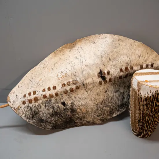 African animal hide and timber shield L-1000 W-460 and small drum