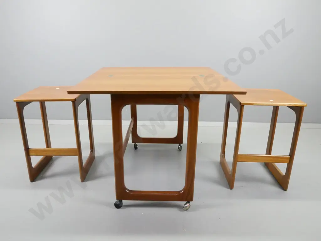 mid-century teak fold-over top tea / games table on casters, with 2 hanging slide out nesting side tables Image 1++