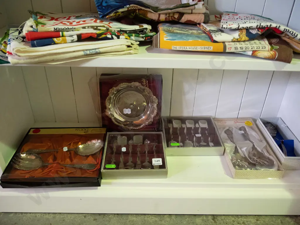 shelf of cased cutlery and a plated bowl Image 1++