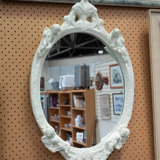 ornate framed cherub themed wall mirror