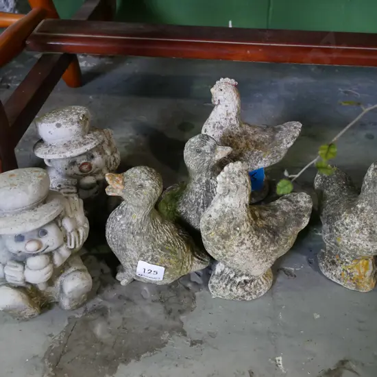 various small concrete gardens - chickens, clowns