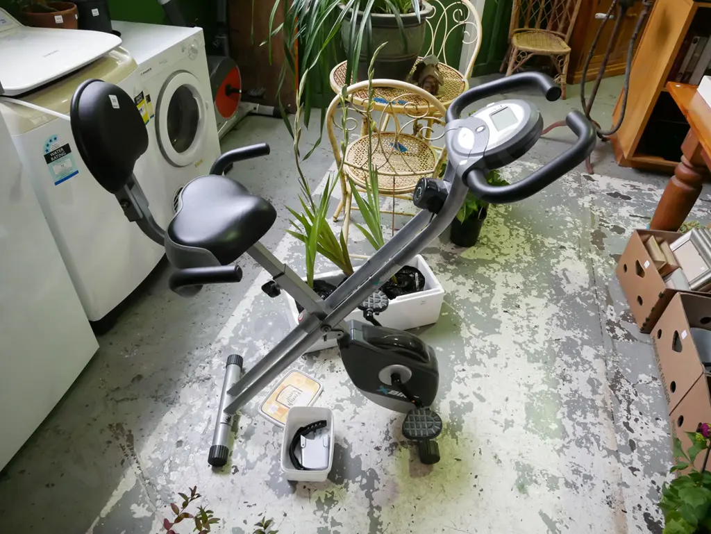 X-bike exercycle, small plastic container of accessories Image 1++