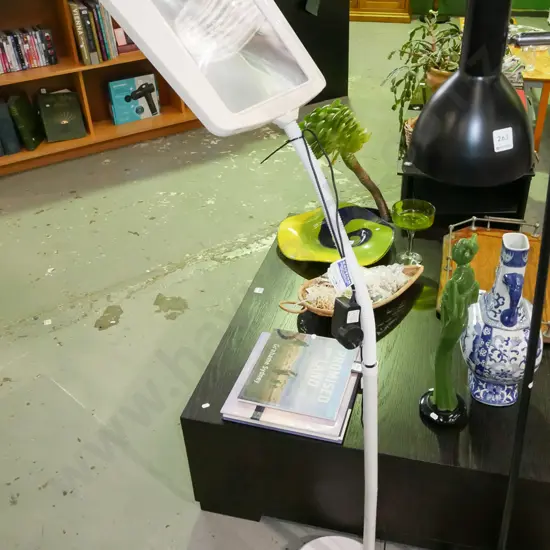 illuminated magnifying glass on stand