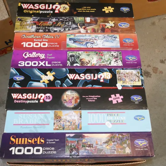 box of wasgji puzzles etc