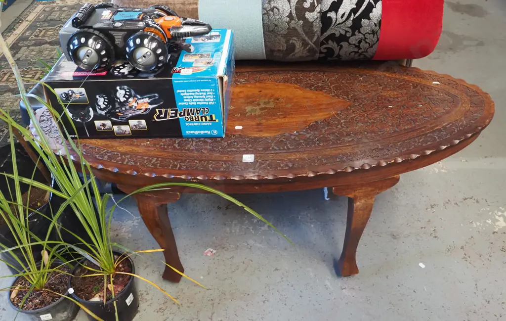 heavily carved middle eastern oval coffee  table with brass inlay Image 1++
