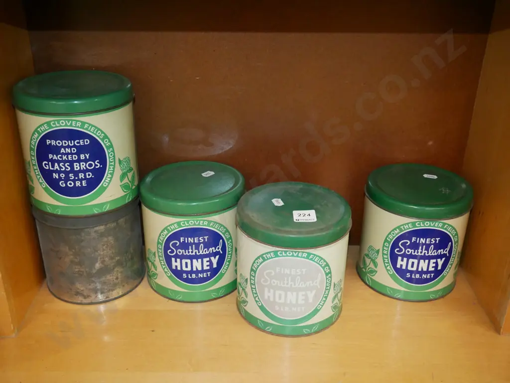 shelf of vintage honey tins Image 1++