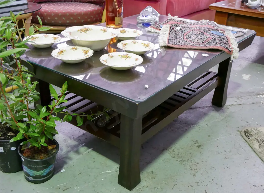 dark stained wooden coffee table with glass top with magazine rack H-445 W-1770 Image 1++