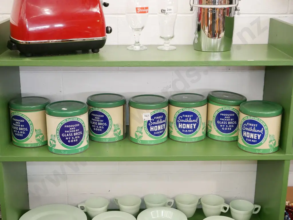 shelf of vintage honey tins Image 1++