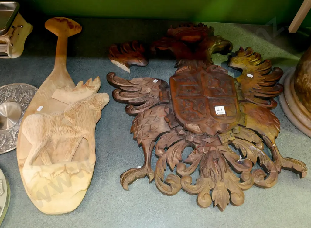 heavily carved wooden shield with coat of arms (piece broken off) and a carved wooden souvenir paddle Image 1++