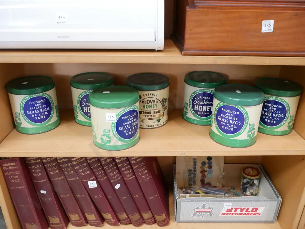 shelf of vintage honey tins Image 1++