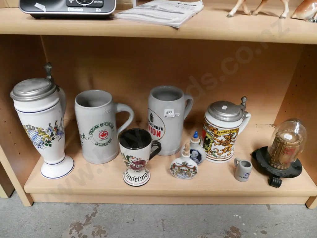 shelf; beer steins, liqueur bottles, souvenir candle Image 1++