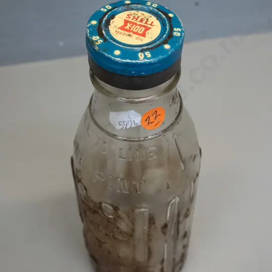 Shell New Zealand One Pint oil bottle with metal cap marked Shell X-100 motor oil