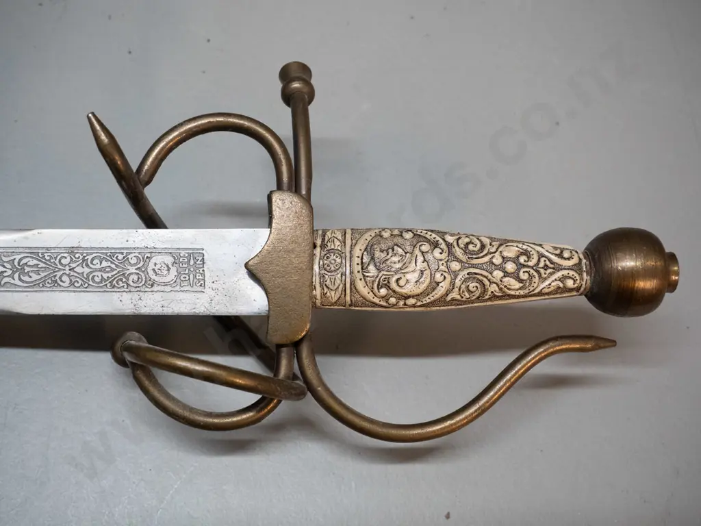 reproduction short sword with faux bone composite handle, brass fittings, etched blade marked Toledo Spain. L-720 Image 1++