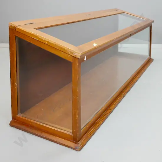 vintage pine sloped top display case with glazed lift up lid, front and sides. Brass key escutcheon but lock removed,