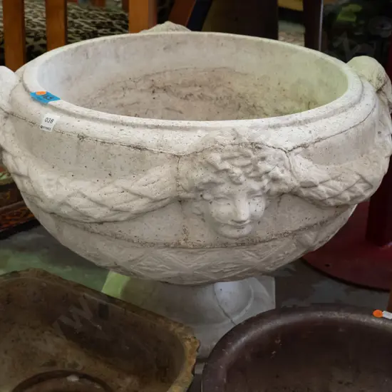 large cast concrete classical style garden urn w/ intertwined swags and female heads, pedestal base on square foot -