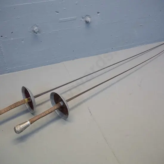 pair of vintage fencing foils with waxed cord wound handles, leather inset in hilt - made in France. One handle has been