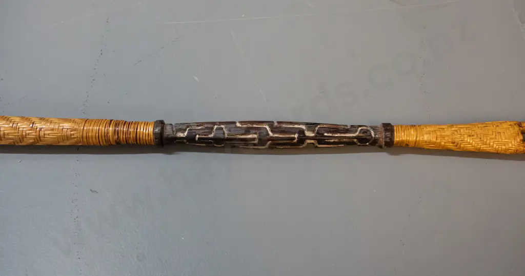 spear (Solomon Islands) with double pronged timber head, carved motifs, shaft covered with woven cane, barbs made from Image 1++